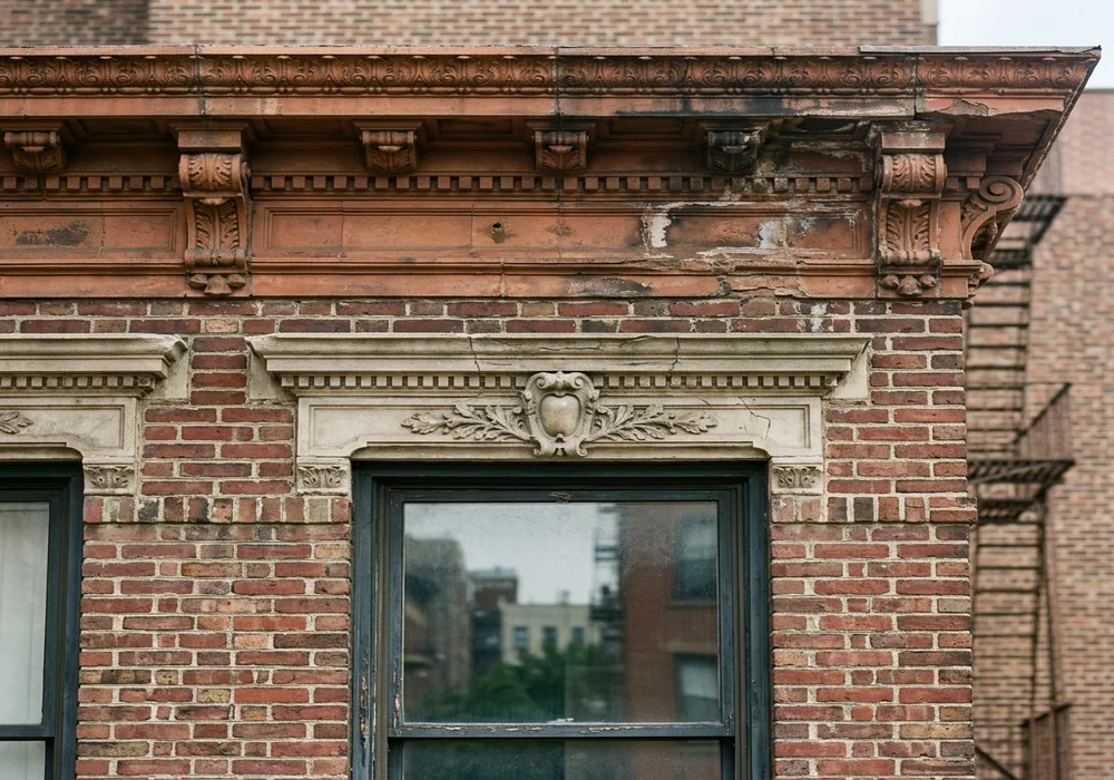 Workers inspecting building brick facade masonry in NYC